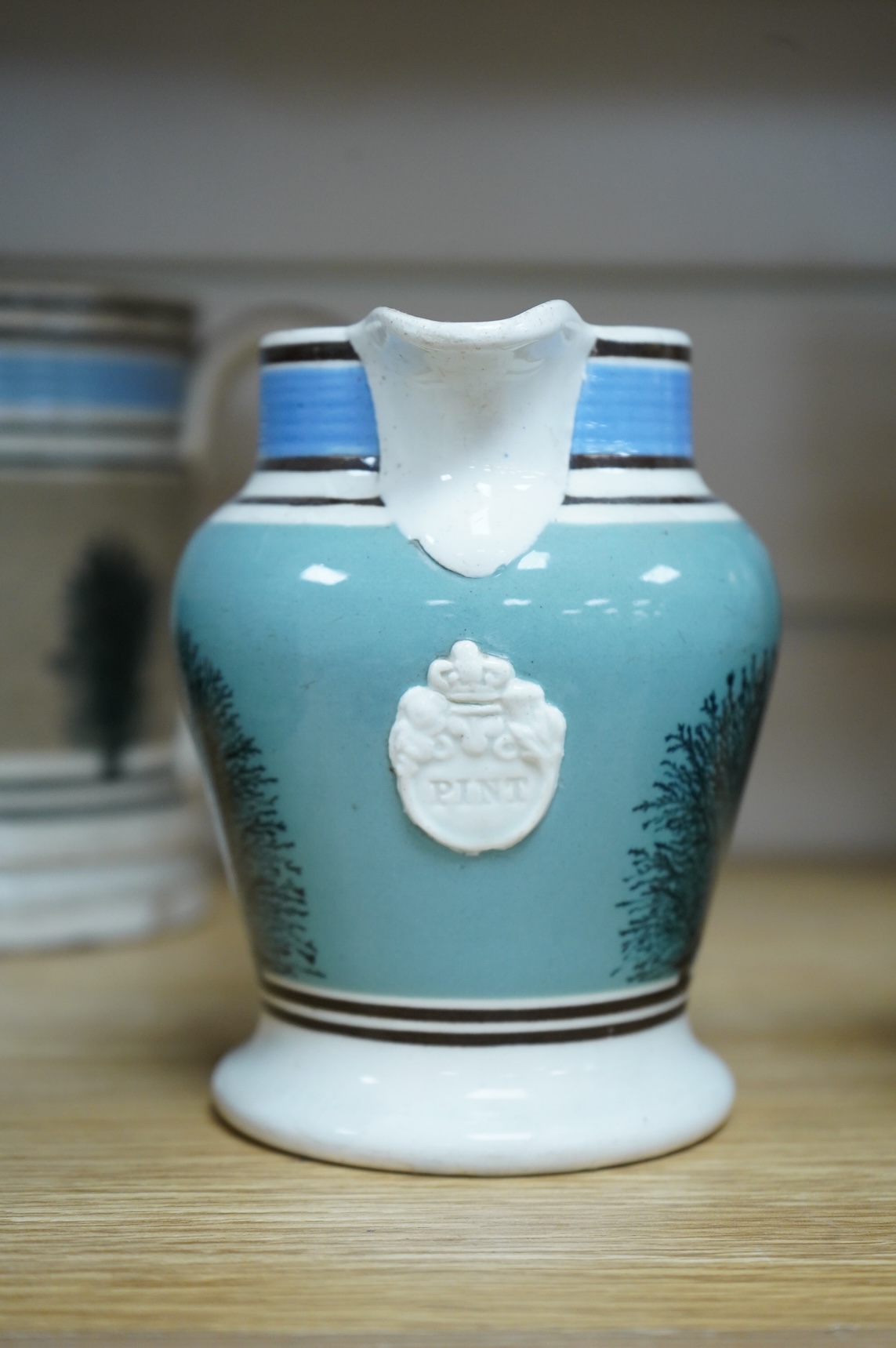 Two early 19th century Mocha ware jugs and two mugs, largest 16cm high